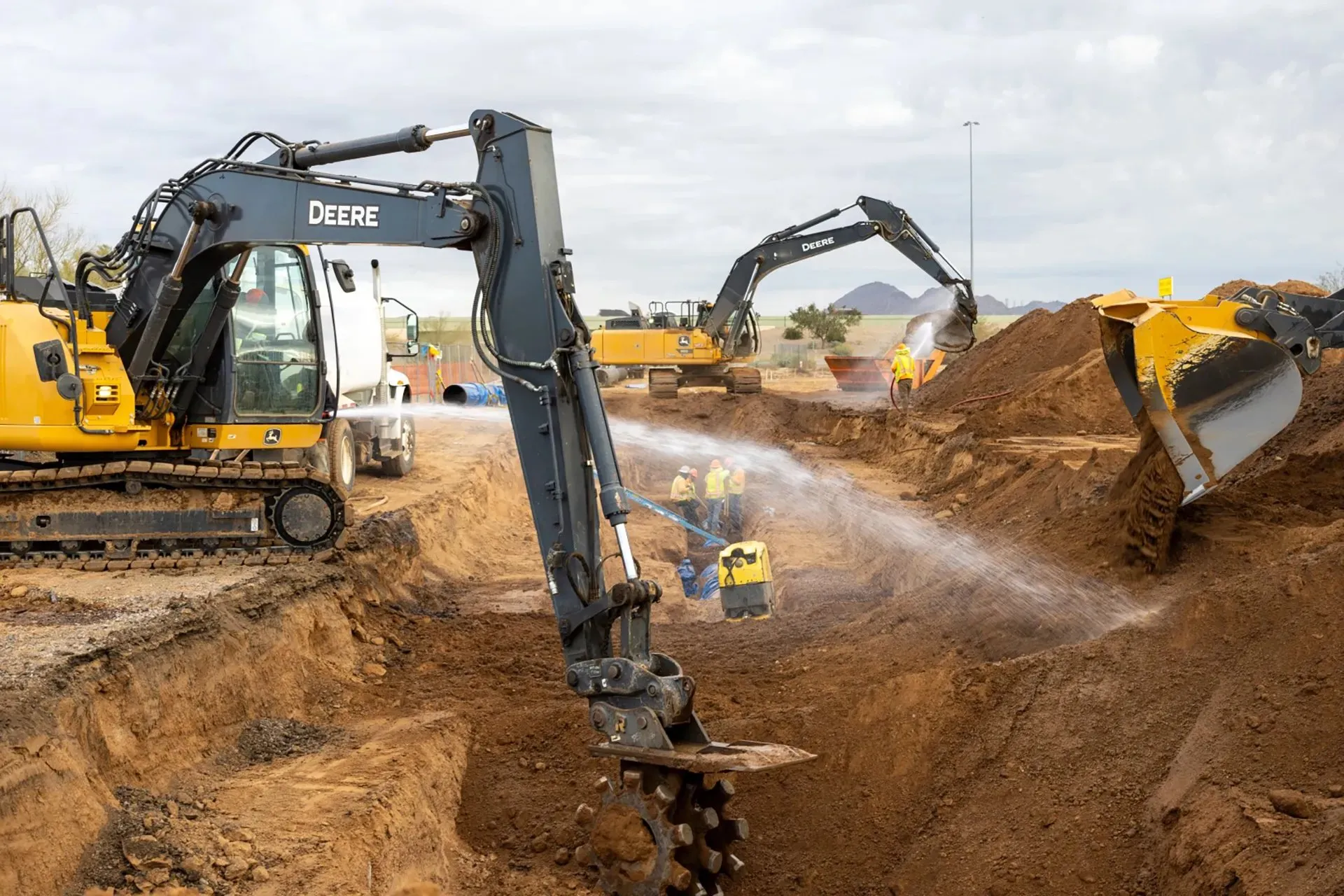 Excavators working in a dusty cut