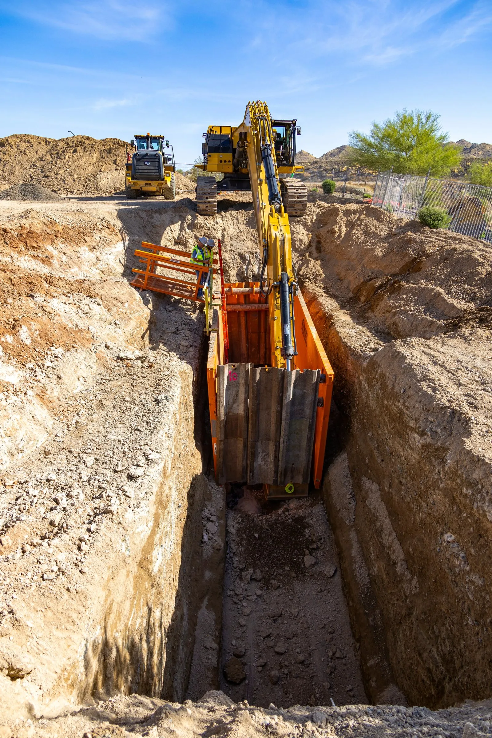 Overhead view down into a deep shored trench